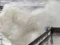 Terrifying moment kid is inches away from huge wave as heavy rain continues