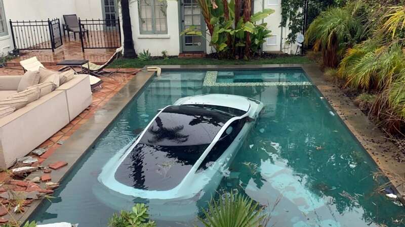 Tesla crashes through wall and into swimming pool as boy, 4, has to be rescued