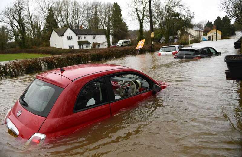 UK weather: Pubs flooded, cars underwater & SEWAGE runs in streets as torrential rain hits - with more chaos to come