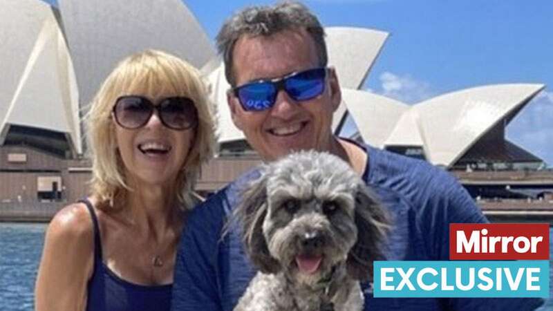 Julie and Jonathan Ashworth outside the Sydney Opera House with cavapoo Charcoal