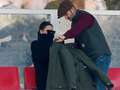 David Beckham wraps 'freezing' Victoria in coat as they watch son play football