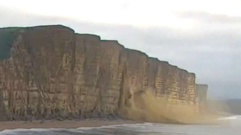 Images show the huge chunk of rock crashing down onto the beach (Image: EnviromentAgency/BNPS)