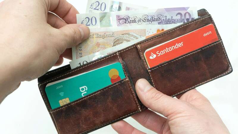 72Point stock image of a hand pulling cash out of a wallet photographed on the 26/01/2023 (Image: © SWNS)