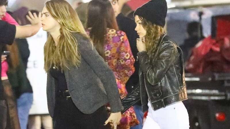 Cara Delevingne holds hands with girlfriend Minke as they watch Harry Styles