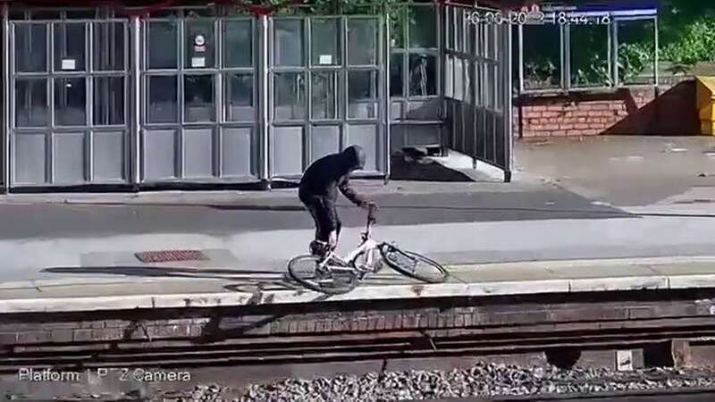 Watch yobs hurl bike onto train tracks - risking major rail derailment