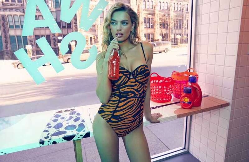 Bregje Heinen stuns while sipping on a bottle of pop in tiger-striped swimsuit