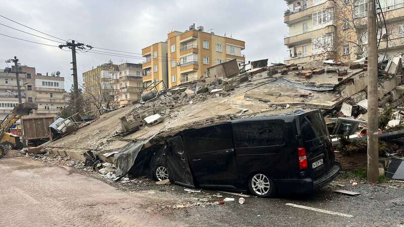 A van under a collapsed building in Sanliurfa, Turkey (Image: PA)