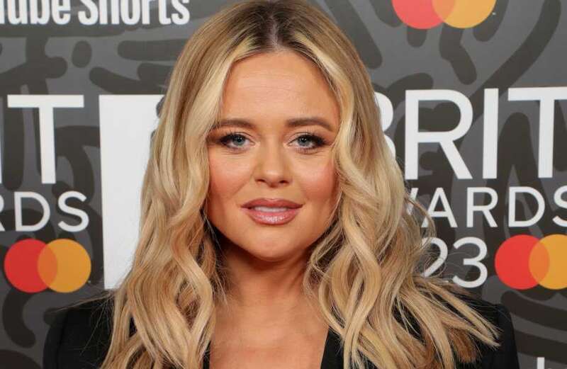 Emily Atack flashes her legs in tiny black leather miniskirt and plunging top