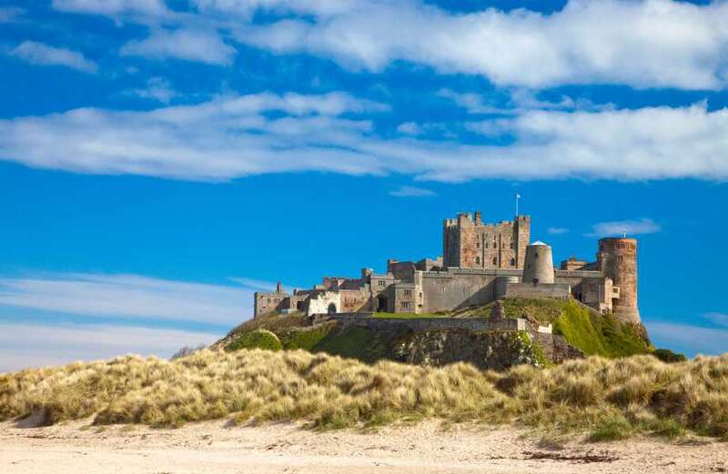 Who owns Bamburgh Castle and why is it so famous?