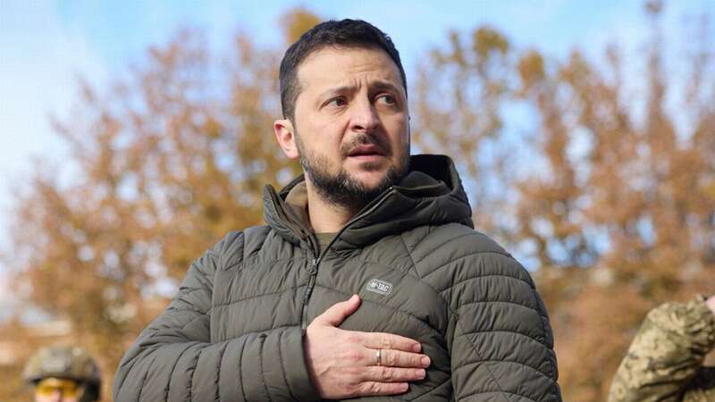 President Volodymyr Zelenskyy listens to the national anthem during his visit to Kherson, Ukraine (Image: AP)