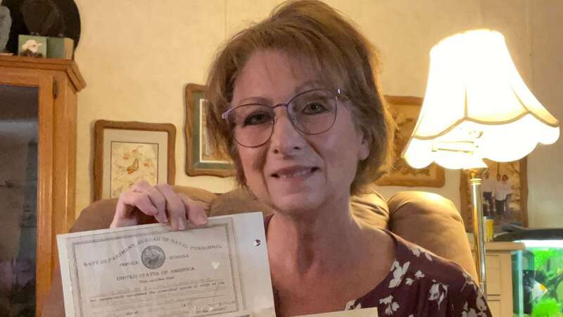 Lisa Hume Lutman with photos of her great uncle, Allen Hudgins, who died aboard USS Albacore (Image: Credit: Lisa Hume Lutman/Pen News)