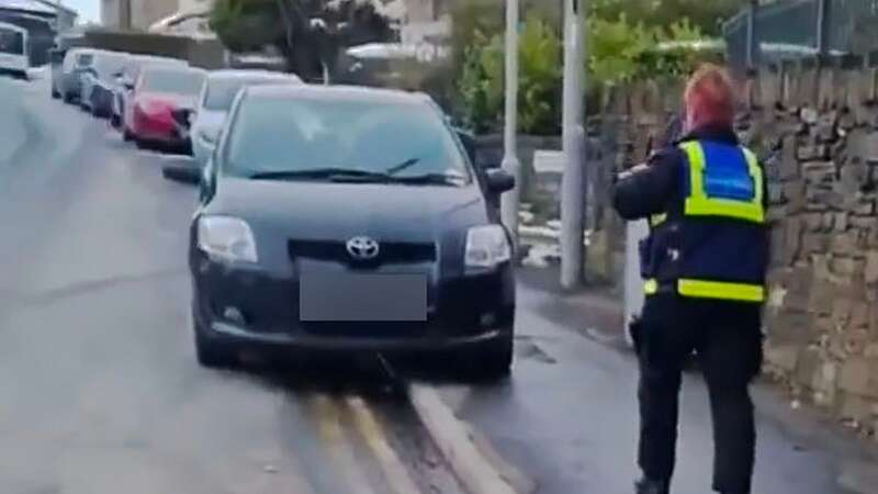 Moment parking officers slap ticket on car left abandoned in blizzard