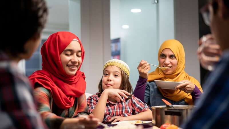 A Muslim family eating Iftar and enjoying breaking of fasting (Image: Getty Images)