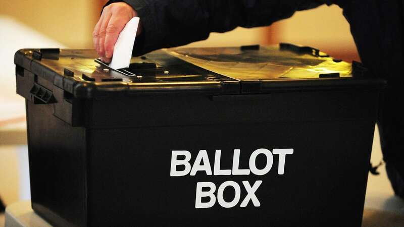 A voter places a paper in the ballot box at a polling station (Image: PA)