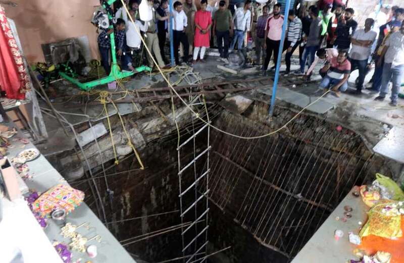 Temple floor collapse sends worshippers plunging into well leaving 35 dead