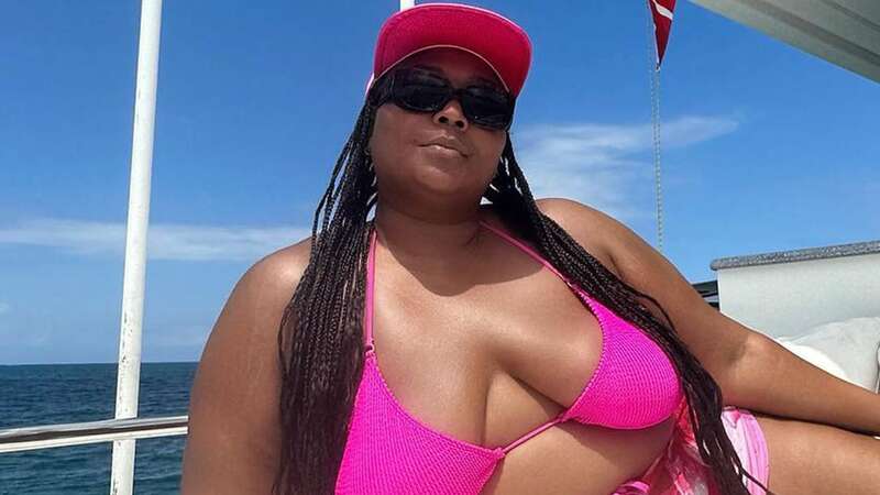 Lizzo looks stunning as she flaunts her curves in a bright pink bikini