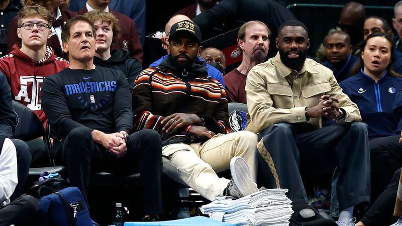 Dallas Mavericks owner Mark Cuban with stars Kyrie Irving and Tim Hardaway Jr who sat the game out (Image: Getty)