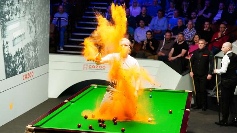 A Just Stop Oil protester jumped on the table and threw orange powder (Image: PA)