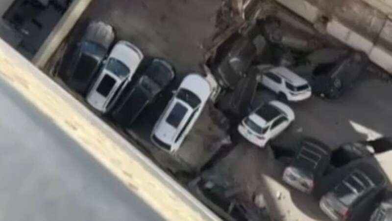 One dead and five injured after parking garage collapses on top of cars