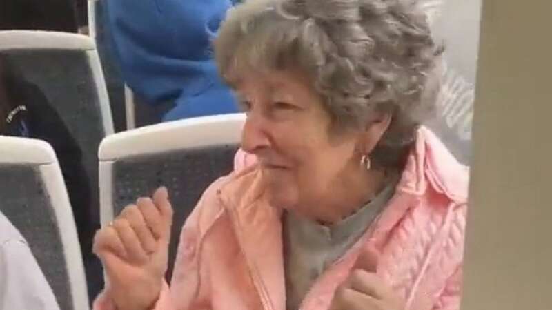 Heartwarming moment children sing along and dance with elderly woman on tram