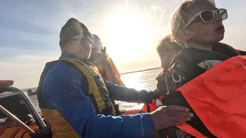 Dramatic moment shipwrecked dad and sons are rescued from sinking boat on fire