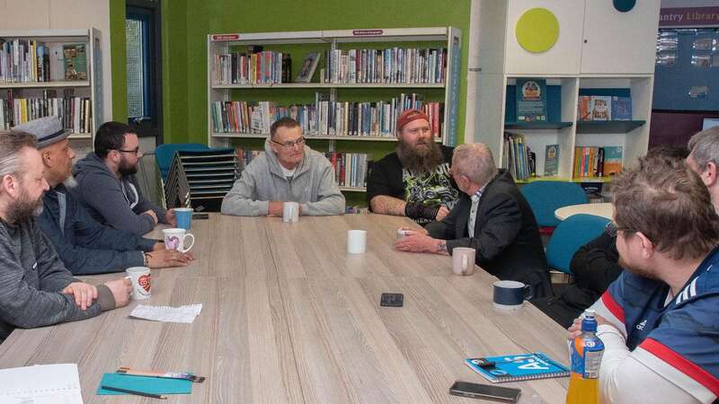 A group of men chatting over a coffee (Image: Charlotte Bond)