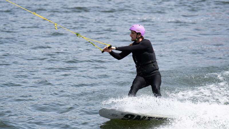 A man wake boards at the Royal Docks in east London (Image: PA)