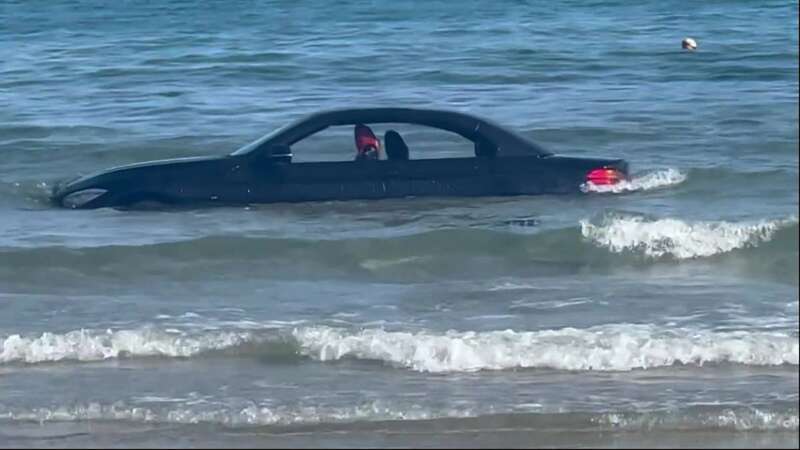 BMW driver roasted for parking convertible on beach as it washes out with tide