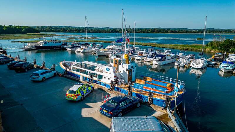 The Dorset Belle in Poole alongside the dock and a police car (Image: MaxWillcock/BNPS)