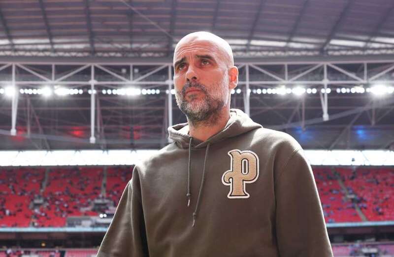 Why does Pep Guardiola have 'mdcr' on his shirt on the touchline?