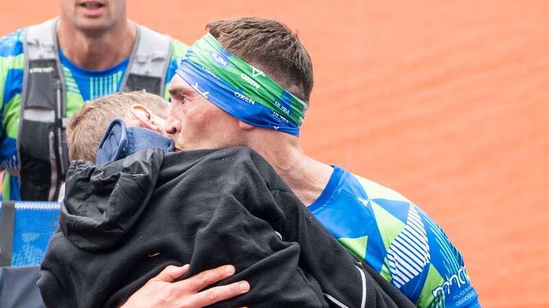 Kevin carries Rob over the line at marathon (Image: PA)