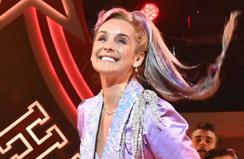 Louise Redknapp flashes her thighs in knee high boots in Grease the Musical