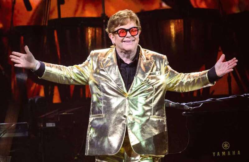 Why does Elton John limp and struggle to walk?