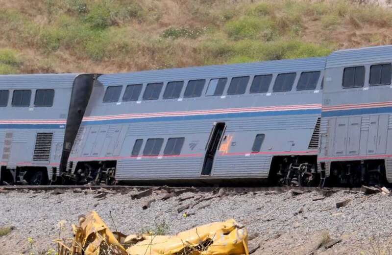 Train derailment sends 15 to hospital after it slams into truck on tracks