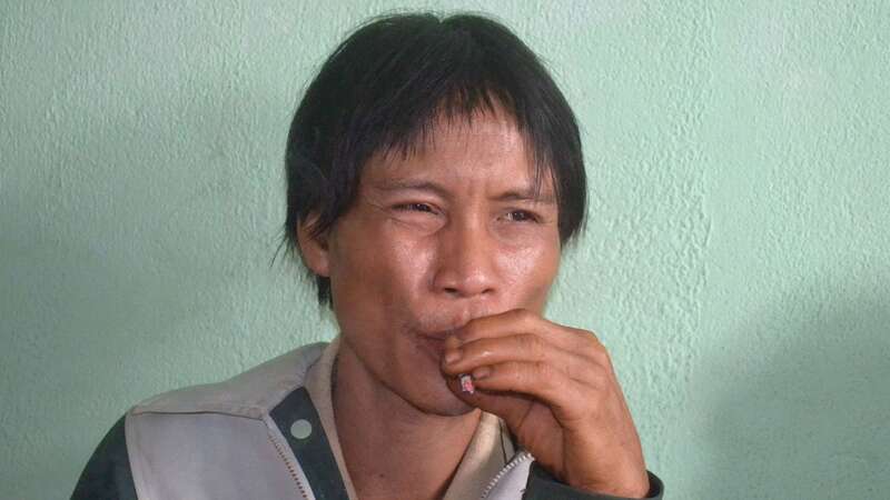 This picture taken on August 8, 2013 shows Ho Van Lang, 42, sitting smoking (Image: AFP via Getty Images)