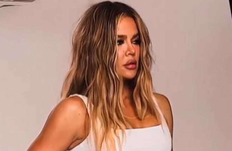 Khloe's waist drowns in baggy jeans as she shows off six-pack abs in new video