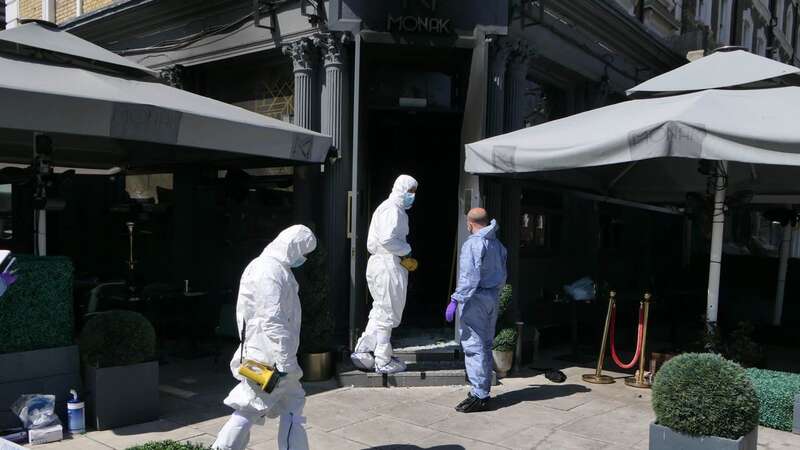 Police at the Monak restaurant following a fire bombing (Image: UkNewsinPictures)