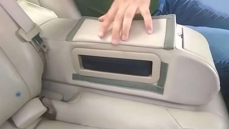 One compartment - found on the 2006 Infiniti G35 - is nestled safely inside the backseat armrest, located on the side once it is pulled down (Image: YOUTUBE/ TECH JOINT)