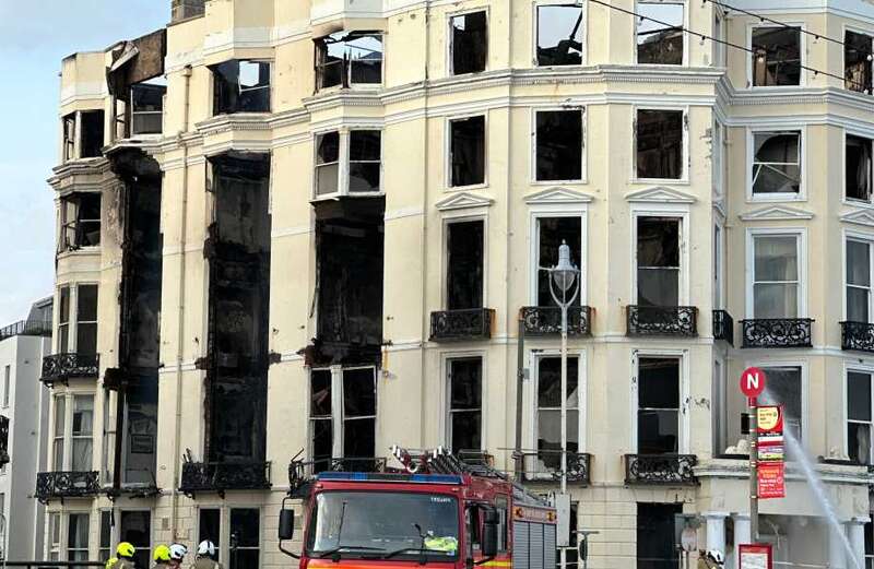 Fire guts hotel as blaze enters third day... with extreme action considered