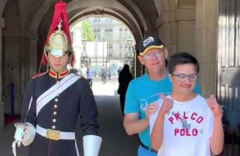 King's Guard breaks protocol to pose with man with Down's syndrome