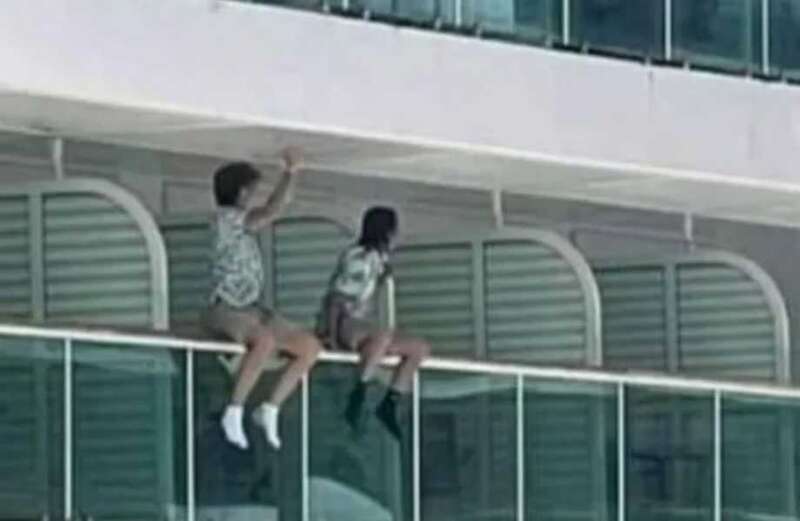 Parents slammed as kids seen dangling legs over cruise ship railings