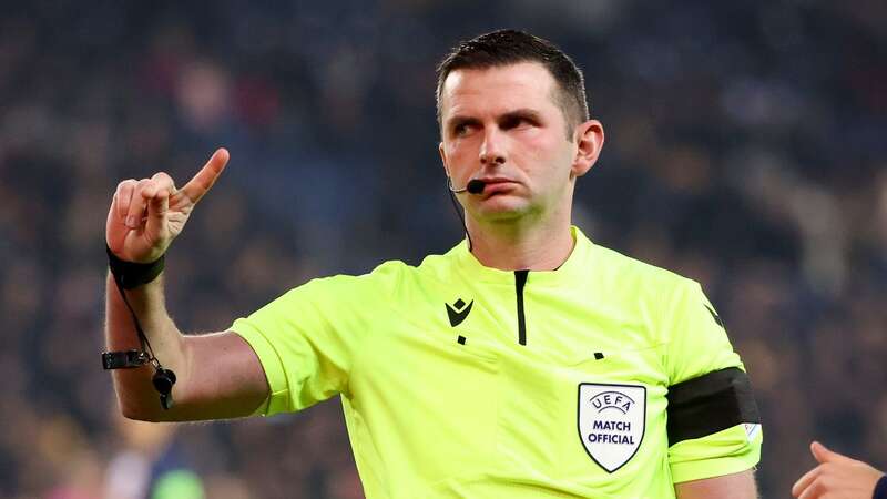 Michael Oliver is surrounded by players during Marseille vs Panathinaikos