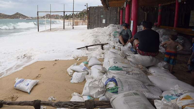 People look at the sea before the arrival of hurricane Hilary at Los Cabos resort in Baja California state, Mexico (Image: AFP via Getty Images)