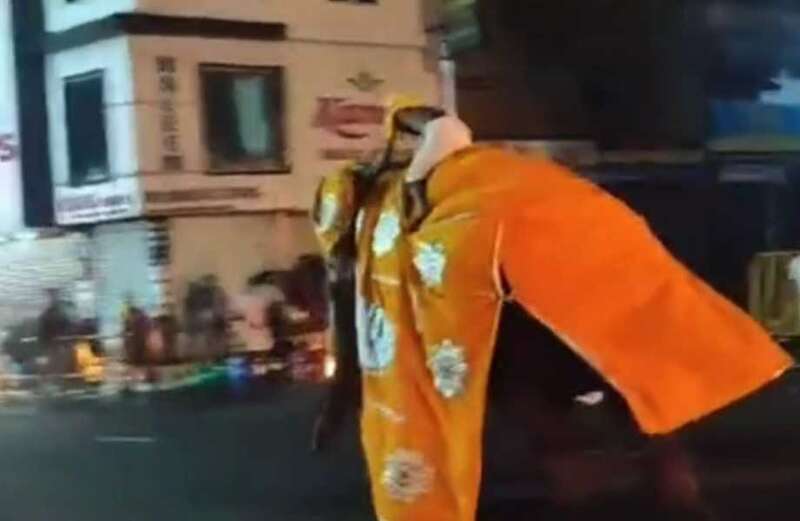 Moment angry elephant goes berserk at Buddhist parade as pilgrims flee