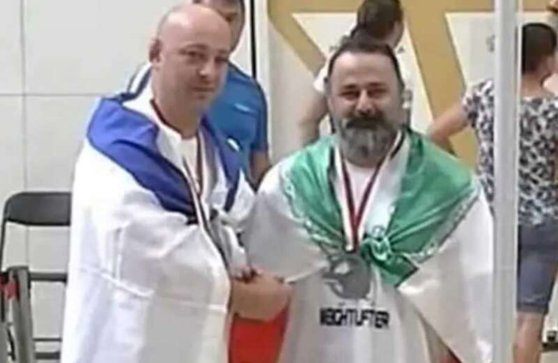 Iranian weightlifter gets life ban after shaking hands with Israeli opponent