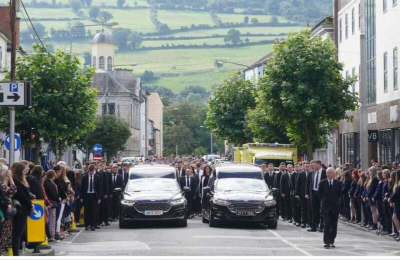 Emotional scenes as town comes to standstill for crash siblings' funeral