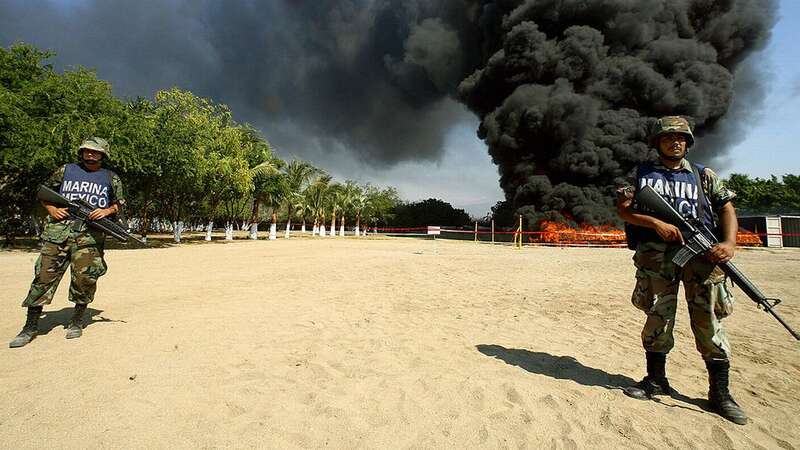 Mexican marines stand watch at the site of the incineration of 23.5 tonnes of cocaine in Manzanillo, state of Colima (Image: AFP via Getty Images)