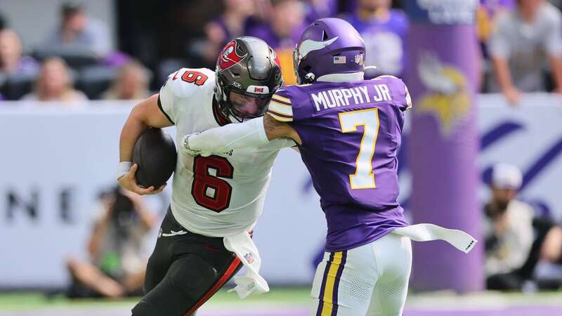 Baker Mayfield #6 of the Tampa Bay Buccaneers runs the ball while Byron Murphy Jr. attempts the tackle