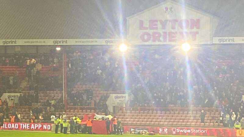 Leyton Orient fans ran onto the pitch to get medical assistance for the supporter (Image: Daily Star)