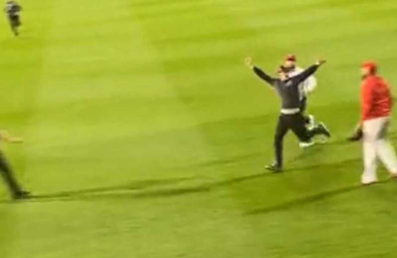 Watch security guard take down fan charging field with brutal tackle